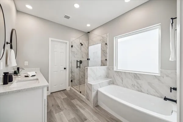 a spacious bathroom with a double vanity sink and a mirror