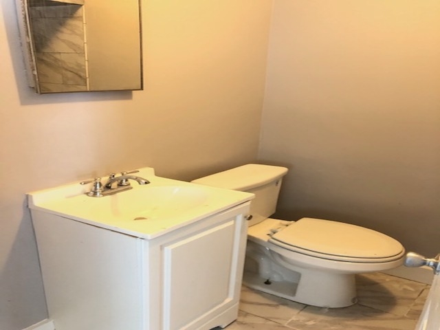 4603 Talley Road Millington, TN 38053 - Photo 11 of 16 a white toilet sitting next to a bathroom sink