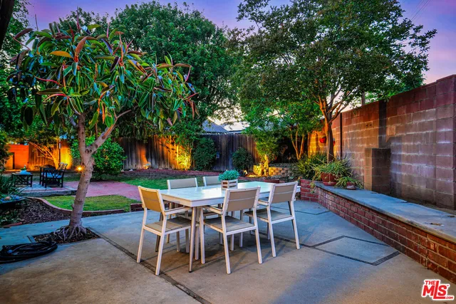 a view of a dining room with furniture and garden