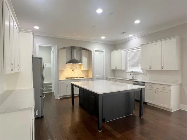 a kitchen with a sink refrigerator and cabinets