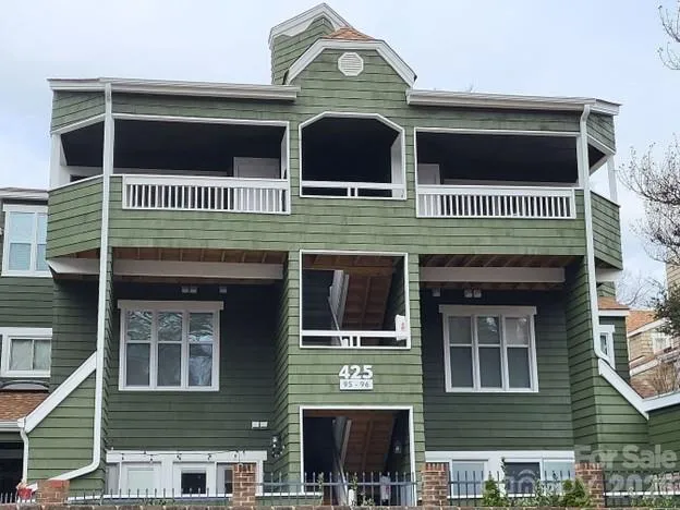 a front view of a house with a front door and brick walls