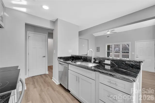 a bathroom with a granite countertop sink a toilet and bathtub