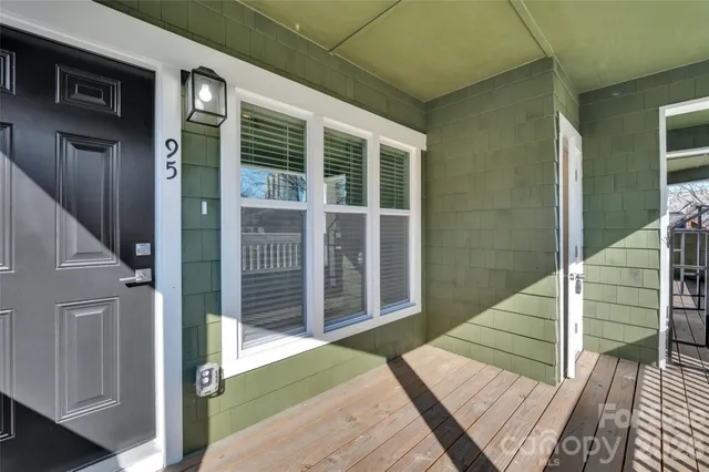 a view of empty room with wooden floor and fireplace