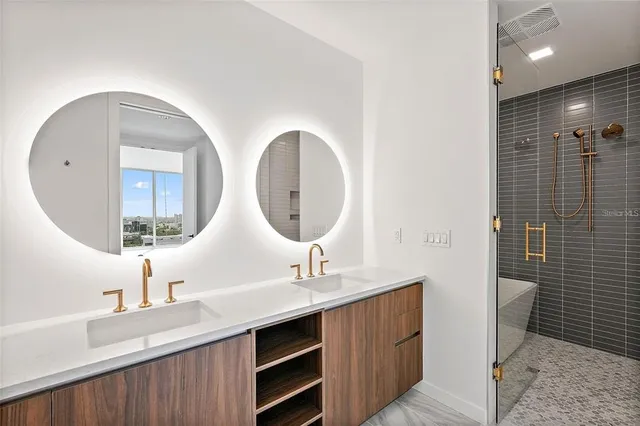 a bathroom with a double vanity sink mirror and toilet