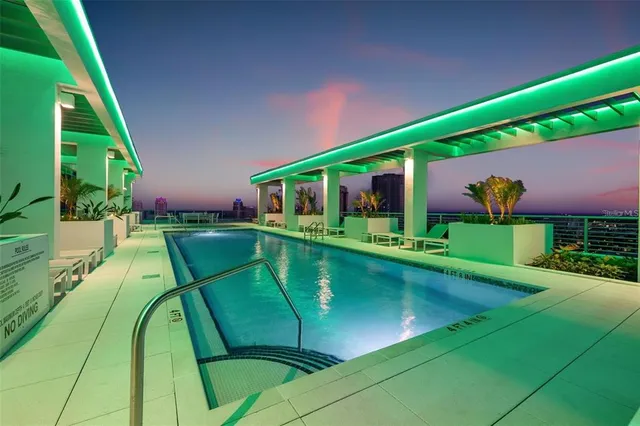 a view of a swimming pool with potted plants
