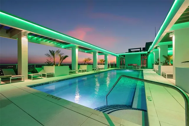 a view of a house with swimming pool and sitting area