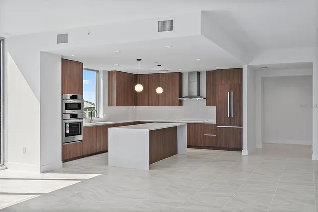 a large kitchen with a stove a sink and dishwasher