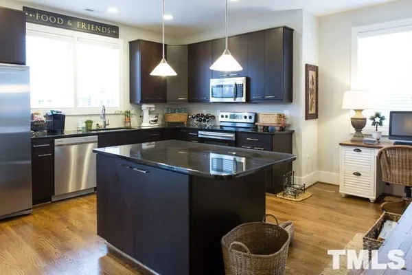 a kitchen with a sink appliances and cabinets