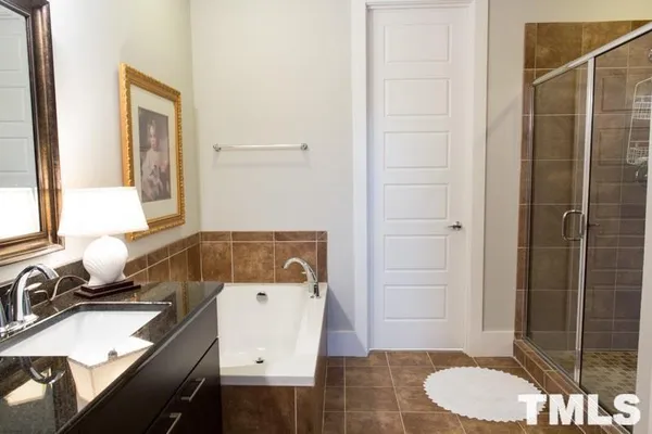 a bathroom with a sink toilet vanity and shower