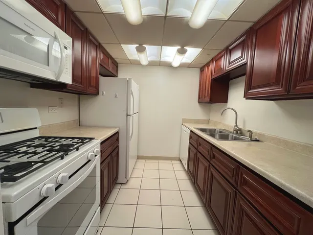a kitchen with granite countertop cabinets and steel stainless steel appliances