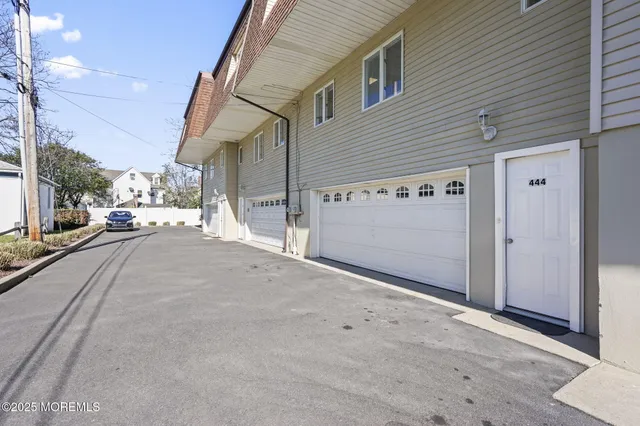 a view of a parking space in front of a house