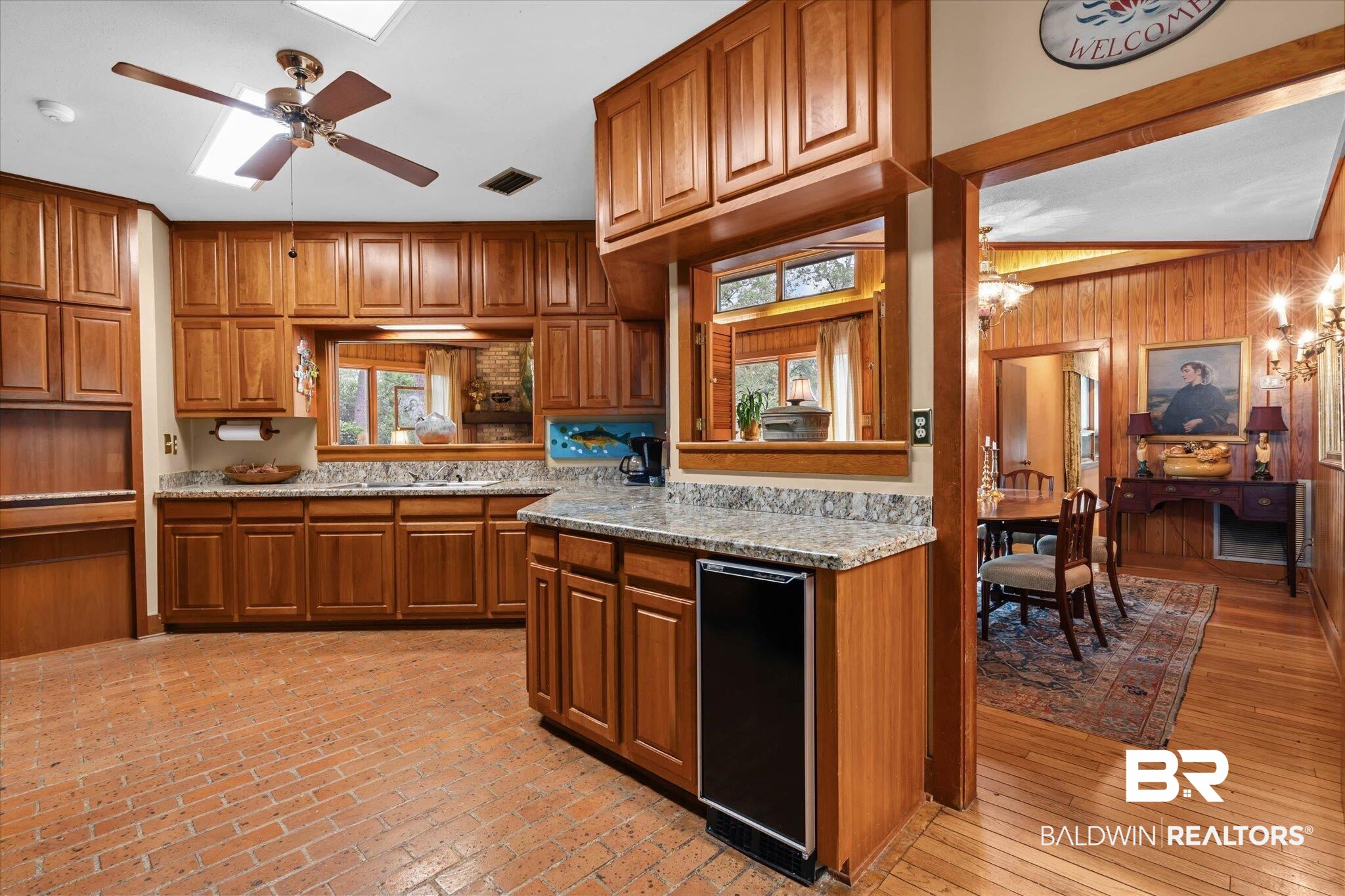 3500 Venetia Road Mobile, AL 36605 - Photo 8 of 56 Kitchen featuring extensive wood cabinetry, granite countertops, an undermount sink, and a built-in beverage refrigerator