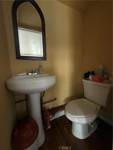 a white toilet sitting next to a bathroom sink