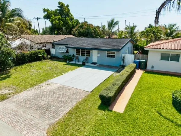 a view of a house with a yard and sitting area