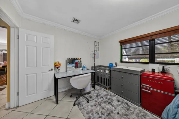 a kitchen that has a sink and chair in it