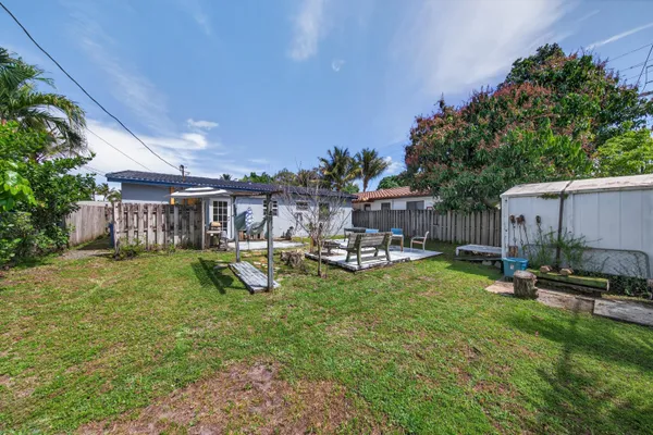 a view of a house with backyard sitting area and garden