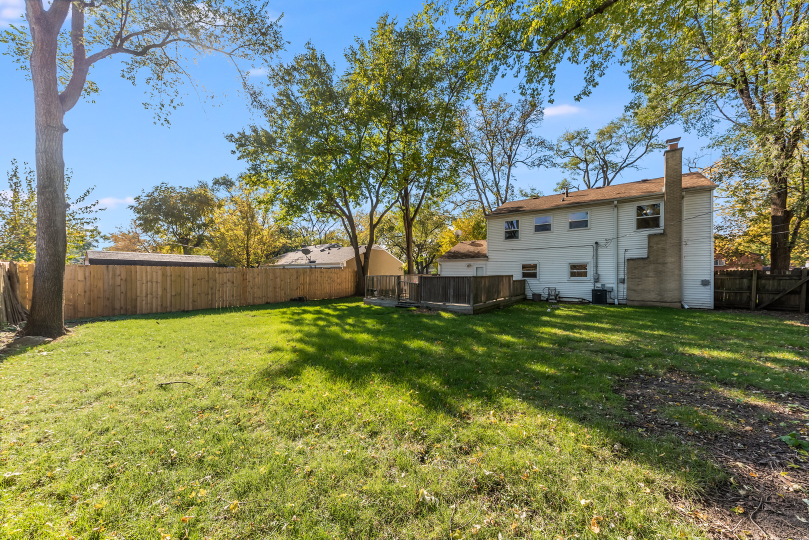 116 North Pinecrest Road Bolingbrook, IL 60440 - Photo 2 of 16 a view of a backyard with plants and large trees