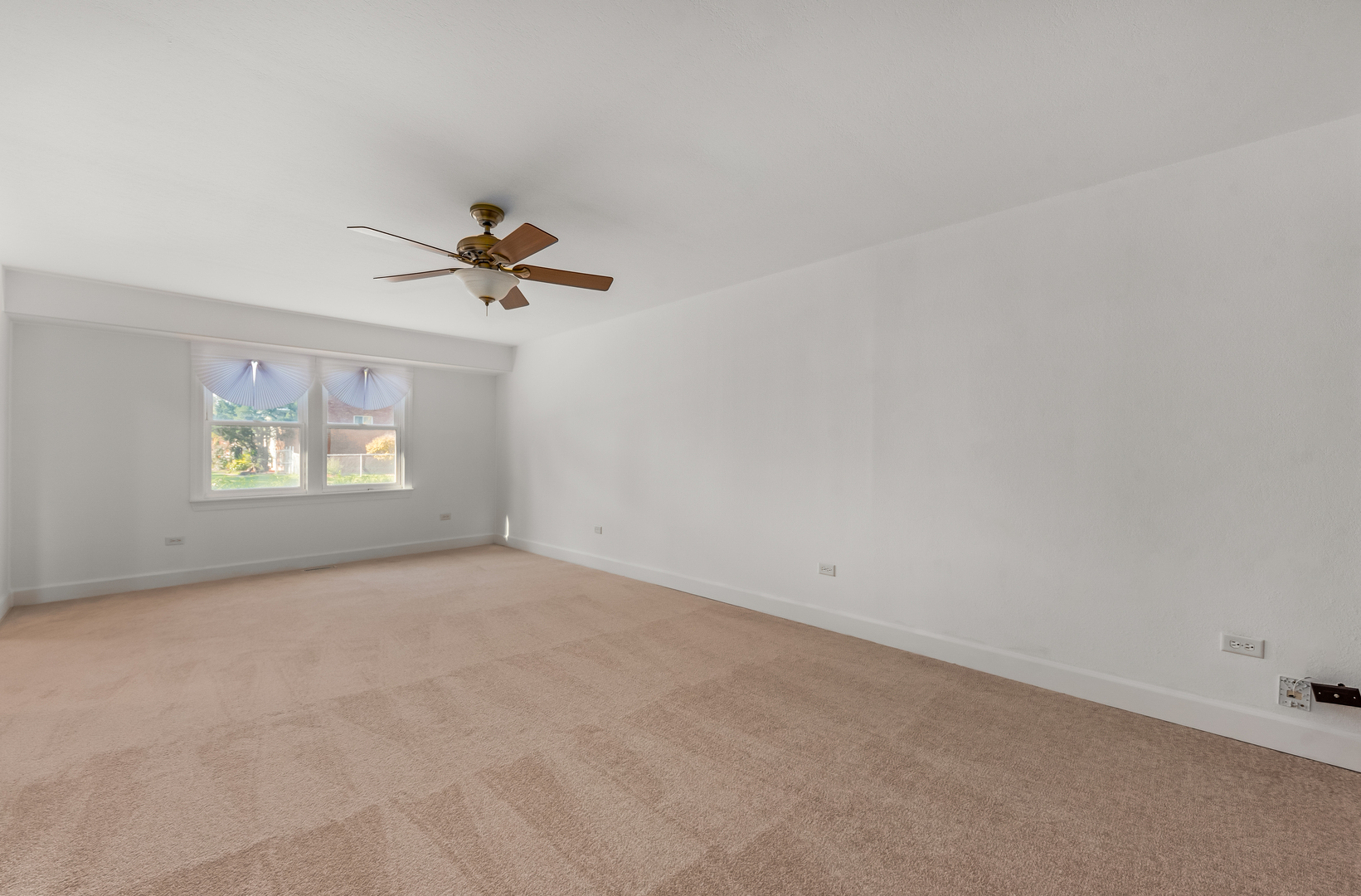 116 North Pinecrest Road Bolingbrook, IL 60440 - Photo 4 of 16 an empty room with a ceiling fan and window