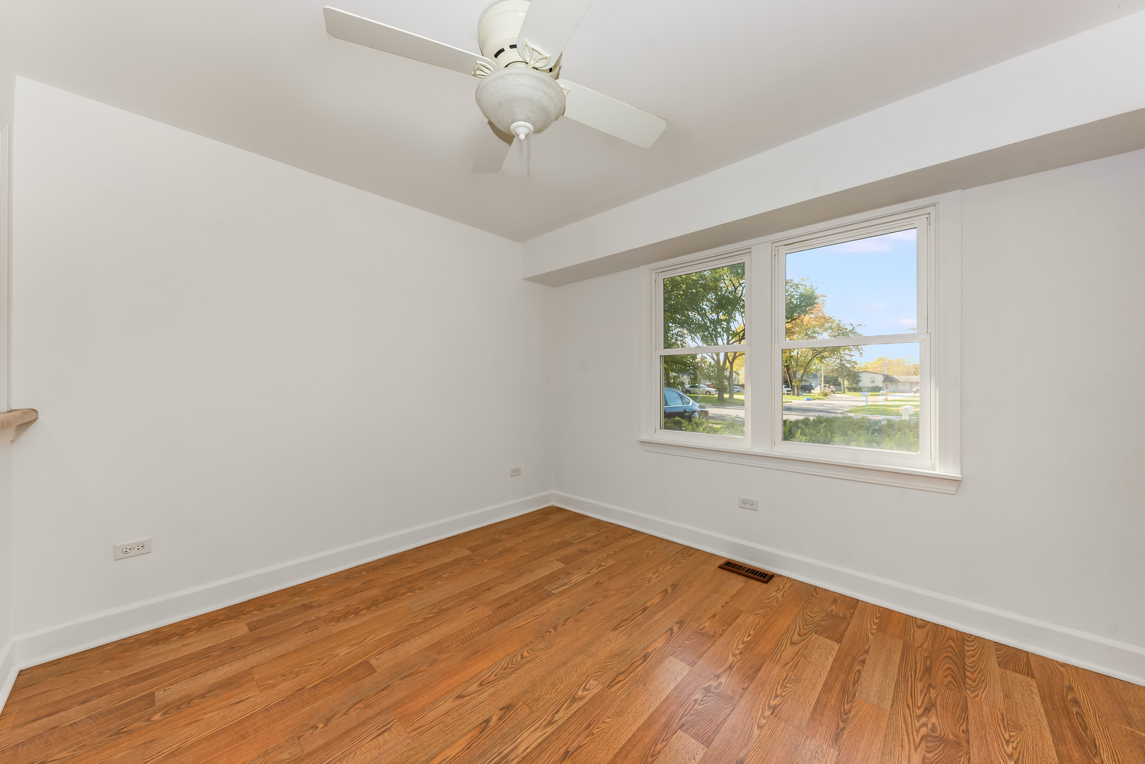 116 North Pinecrest Road Bolingbrook, IL 60440 - Photo 8 of 16 wooden floor in an empty room with a window