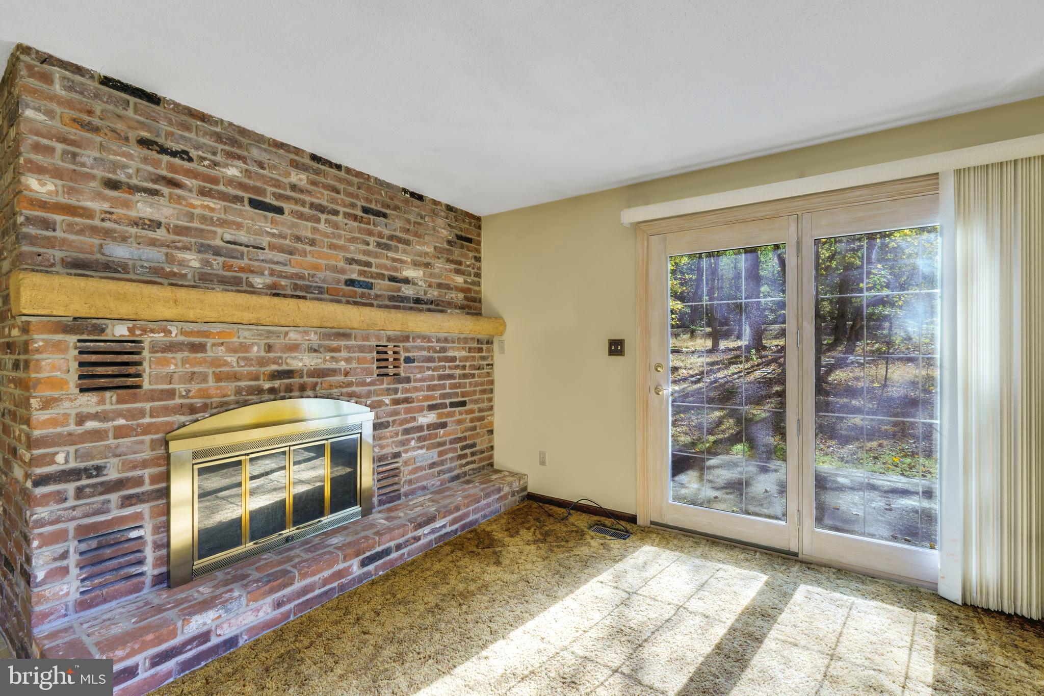 2333 Three Mile Run Road Perkasie, PA 18944 - Photo 13 of 43 a view of empty room with floor to ceiling window and fireplace