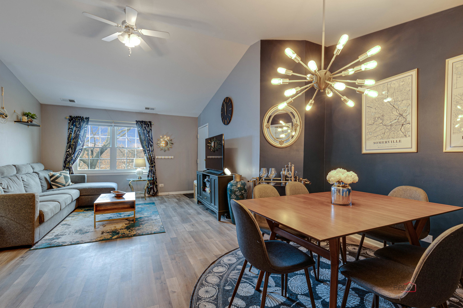 122 East Winchester Road, Unit E Libertyville, IL 60048 - Photo 2 of 17 a living room with furniture and a clock