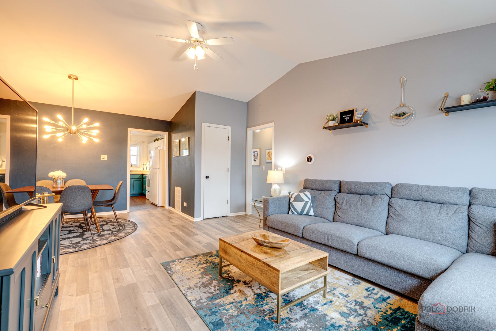 122 East Winchester Road, Unit E Libertyville, IL 60048 - Photo 3 of 17 a living room with furniture a rug and a chandelier