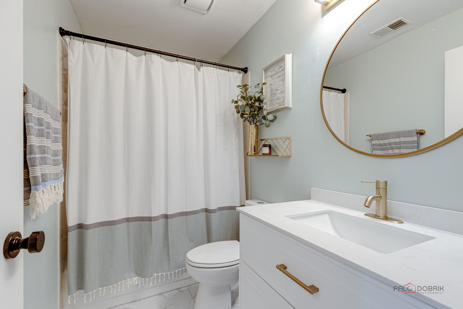 122 East Winchester Road, Unit E Libertyville, IL 60048 - Photo 9 of 17 a bathroom with a sink and mirror with toilet