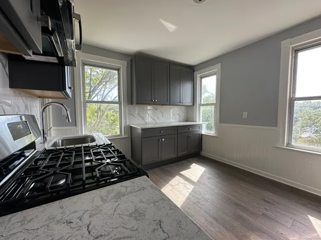 a kitchen with sink a window and stainless steel appliances