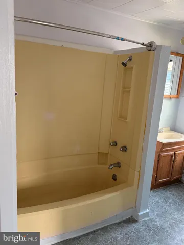 a bathroom with a shower and a bath tub