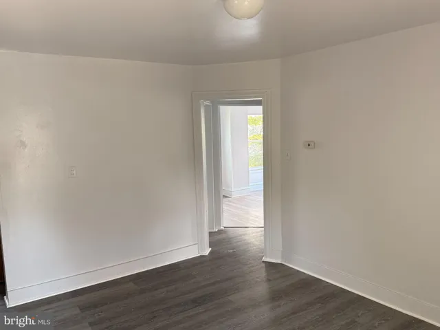 a view of an empty room and wooden floor