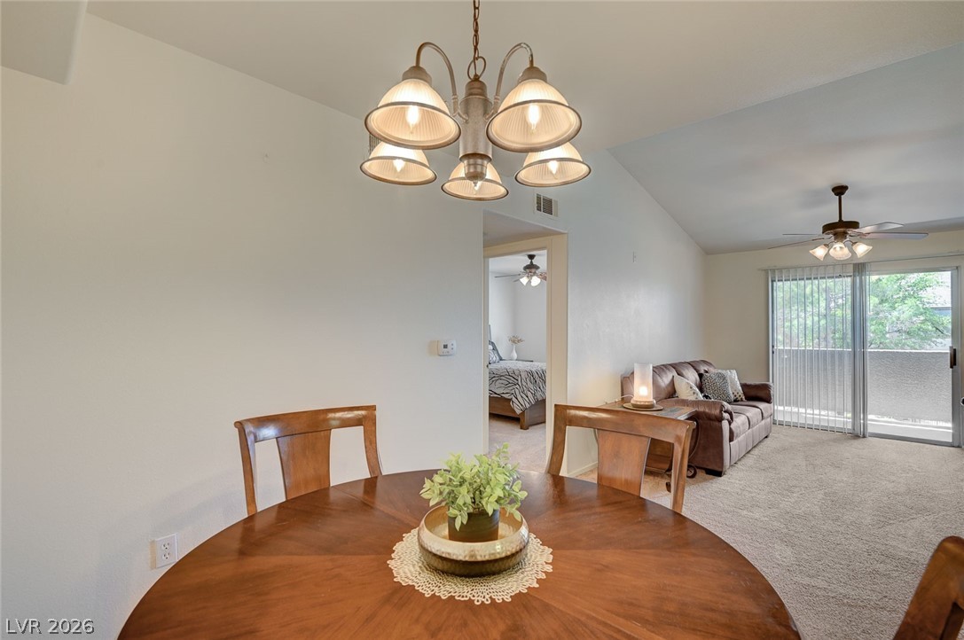 555 East Silverado Ranch Boulevard, Unit 2124 Las Vegas, NV 89183 - Photo 14 of 47 A welcoming dining area seamlessly transitions into a comfortable living space with outdoor access.