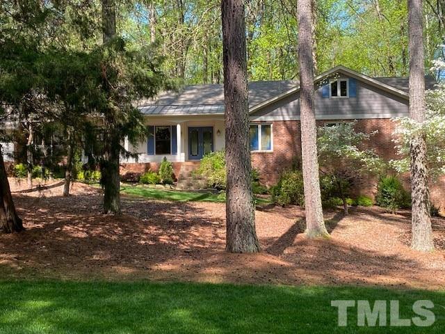 9627 Barton Creek Road Raleigh, NC 27615 - Photo 2 of 30 a front view of a house with garden