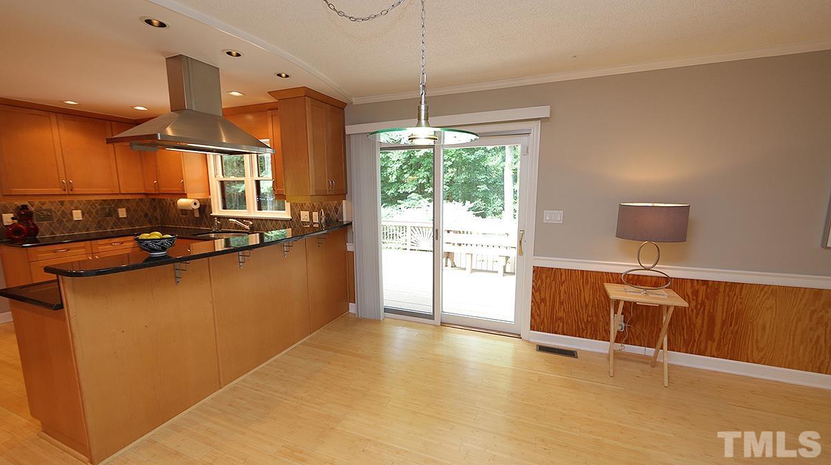 9627 Barton Creek Road Raleigh, NC 27615 - Photo 11 of 30 a kitchen with stainless steel appliances granite countertop a stove a sink and a refrigerator