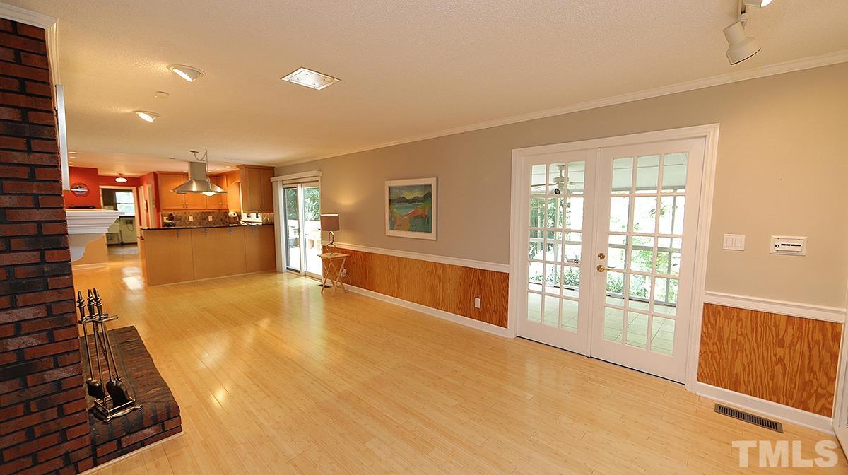9627 Barton Creek Road Raleigh, NC 27615 - Photo 14 of 30 a view of a living room with furniture and a flat screen tv
