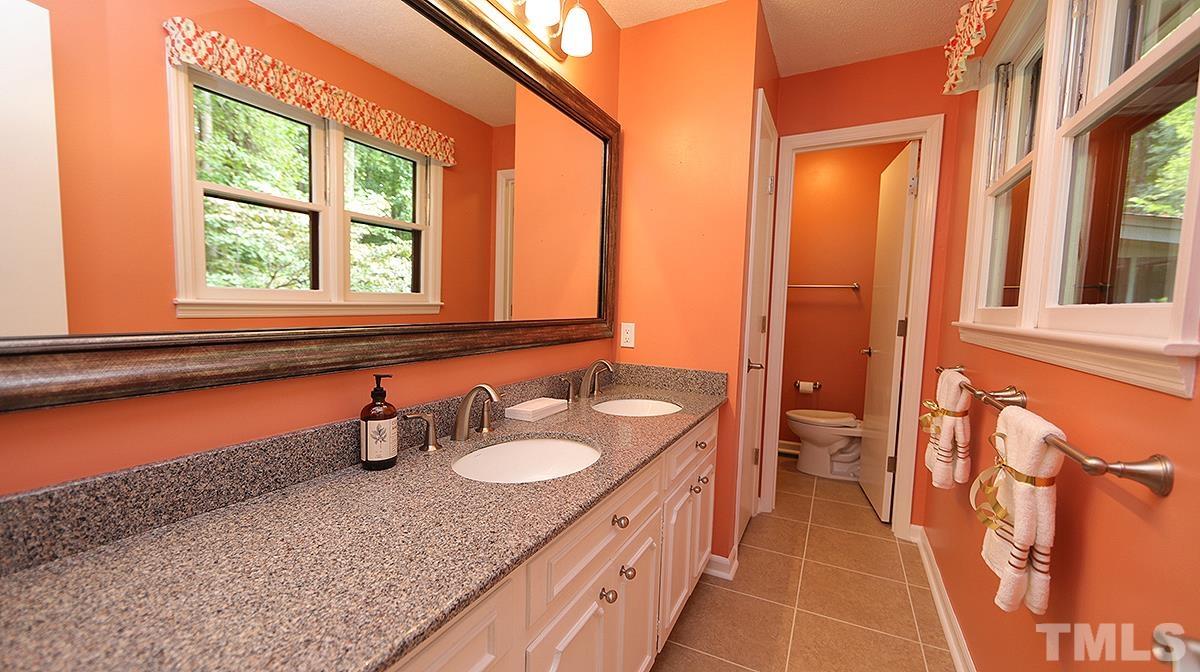 9627 Barton Creek Road Raleigh, NC 27615 - Photo 16 of 30 a bathroom with a granite countertop sink and a mirror