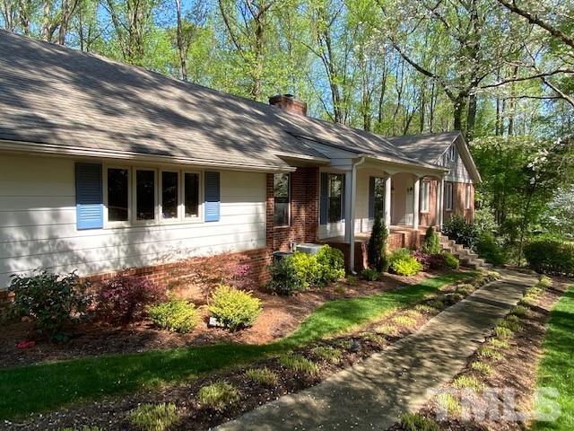 9627 Barton Creek Road Raleigh, NC 27615 - Photo 3 of 30 a front view of a house with garden