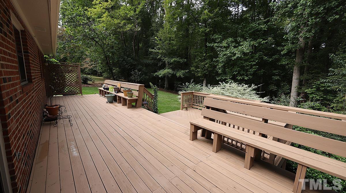 9627 Barton Creek Road Raleigh, NC 27615 - Photo 25 of 30 a view of a wooden deck with a bench