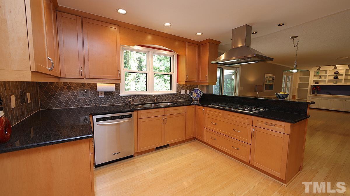 9627 Barton Creek Road Raleigh, NC 27615 - Photo 7 of 30 a kitchen with stainless steel appliances granite countertop a sink a stove and a refrigerator