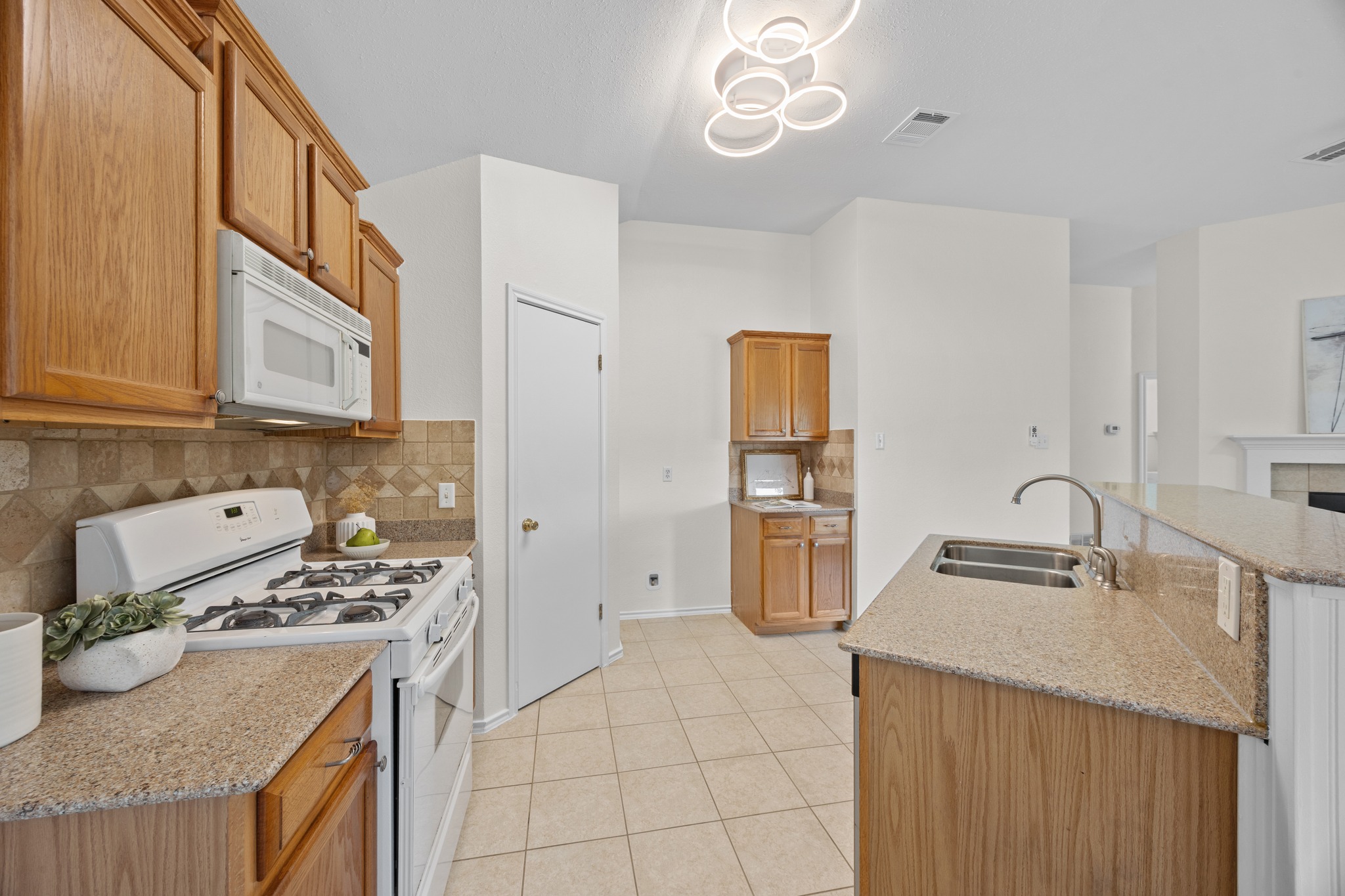 8219 Edgemoor Place Austin, TX 78749 - Photo 18 of 30 Updated lighting recently installed in the kitchen.