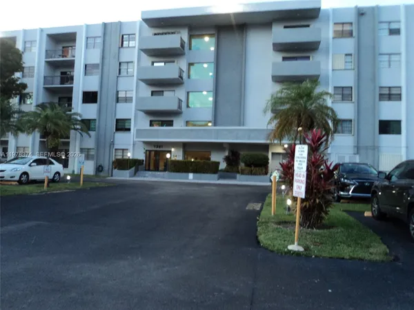 a front view of a building with a yard