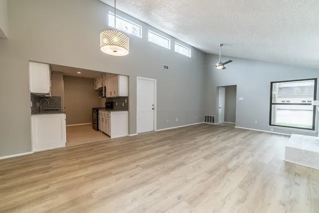 a view of a kitchen with a sink and a refrigerator