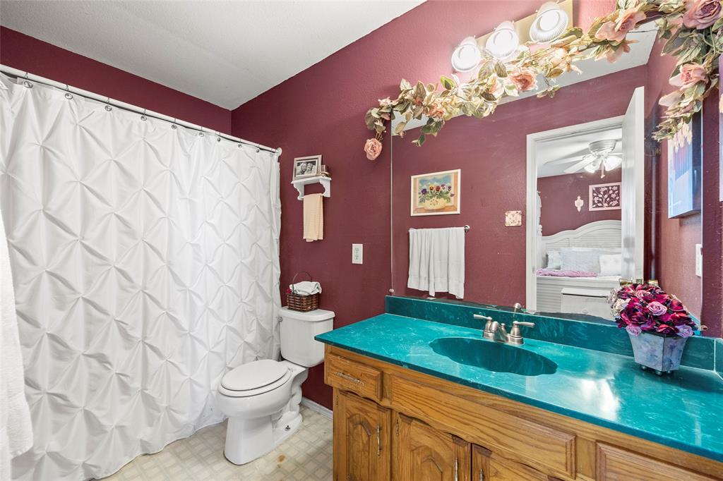 482 Prince Lane Fate, TX 75087 - Photo 20 of 32 a bathroom with a sink a mirror and a toilet