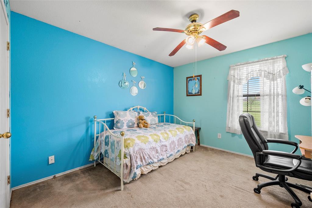 482 Prince Lane Fate, TX 75087 - Photo 22 of 32 a bedroom with a bed and a chandelier
