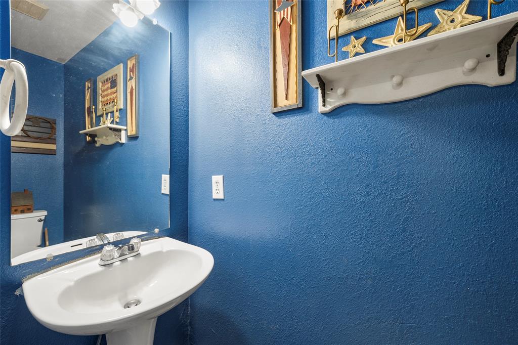 482 Prince Lane Fate, TX 75087 - Photo 27 of 32 a bathroom with a sink and a mirror