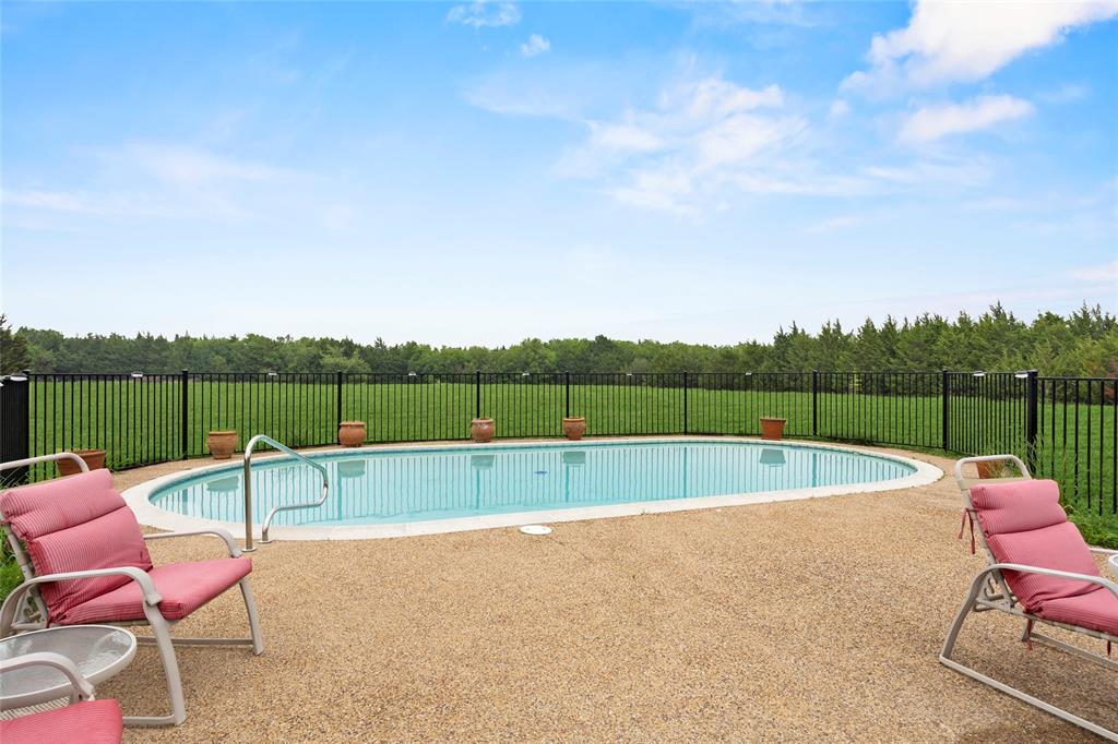 482 Prince Lane Fate, TX 75087 - Photo 30 of 32 a view of a swimming pool with a lounge chair