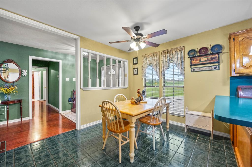 482 Prince Lane Fate, TX 75087 - Photo 8 of 32 a dining room with furniture a rug and wooden floor