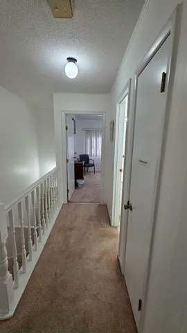 a view of a hallway view with staircase