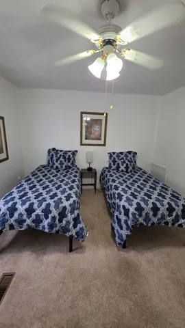 a bedroom with bed and window