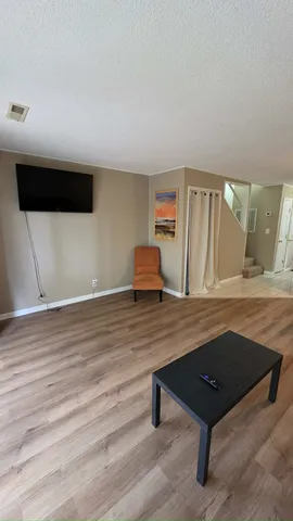 a room with wooden floor and furniture