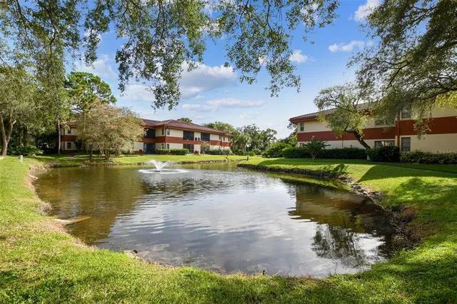 a view of a swimming pool with a patio and a fire pit